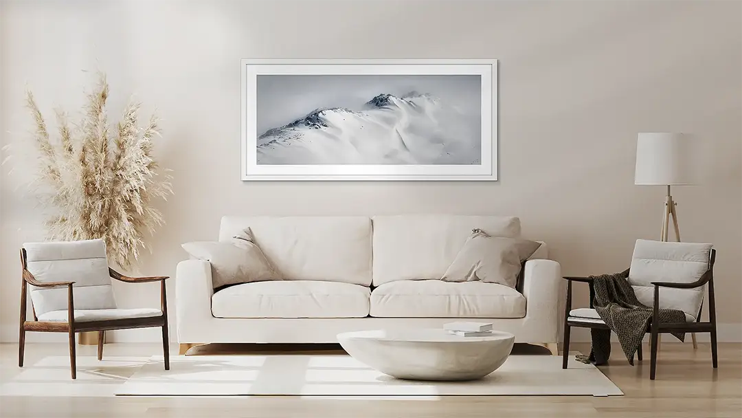 Aerial wall art artwork in white frame above couch.