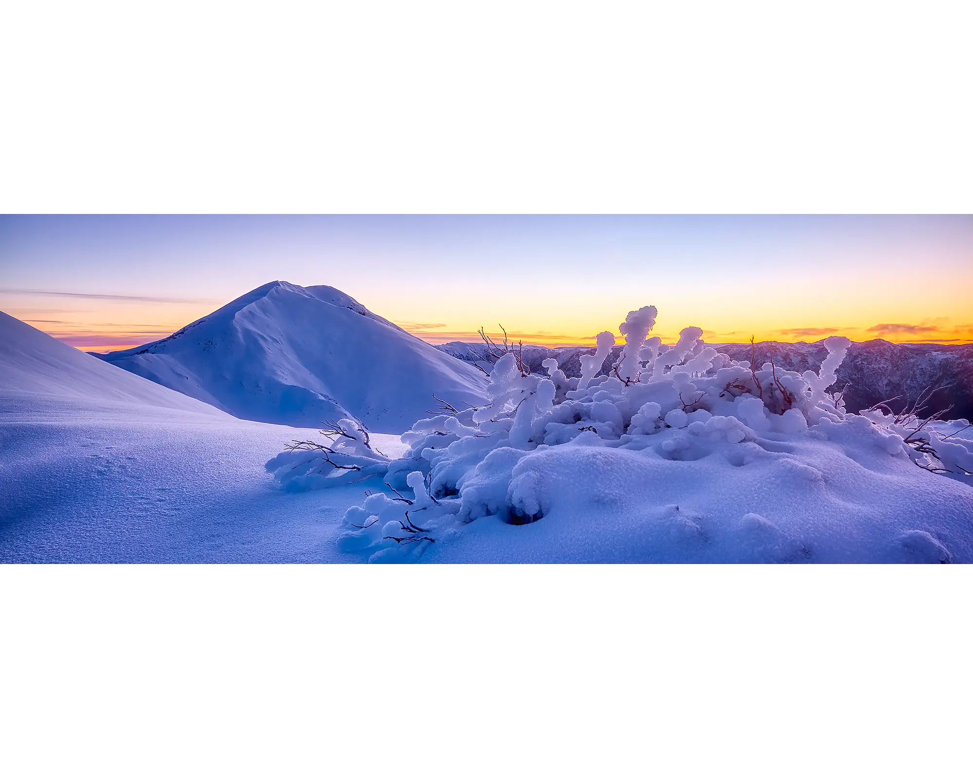 Sunrise behind Mount Feathertop with winter snow, Alpine National Park, Victoria. 