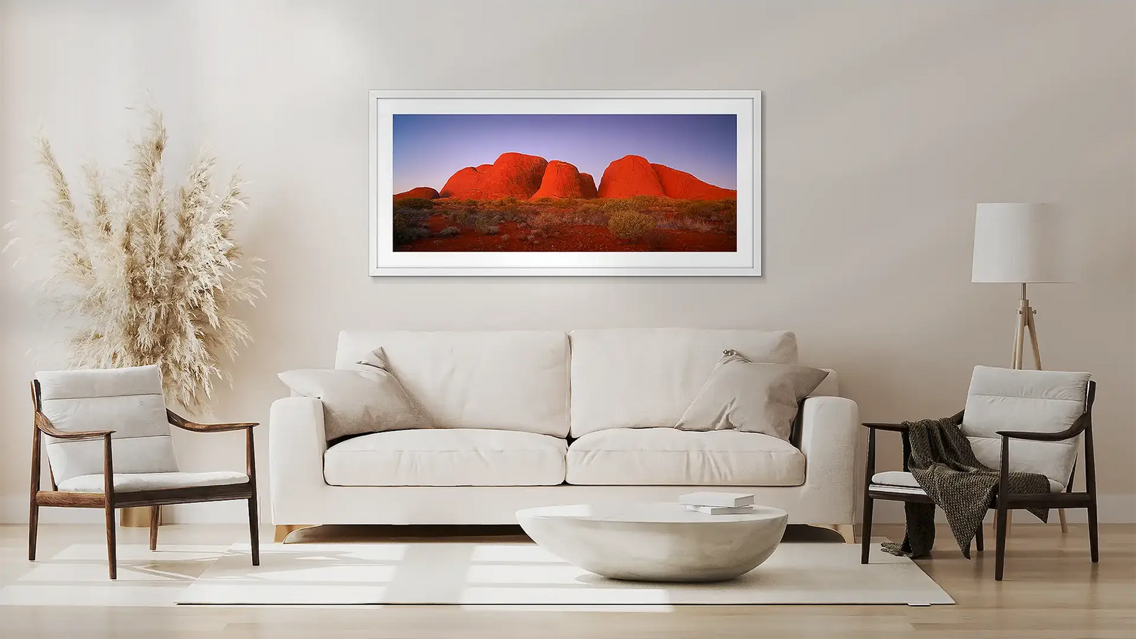 Outback wall art in white frame above couch