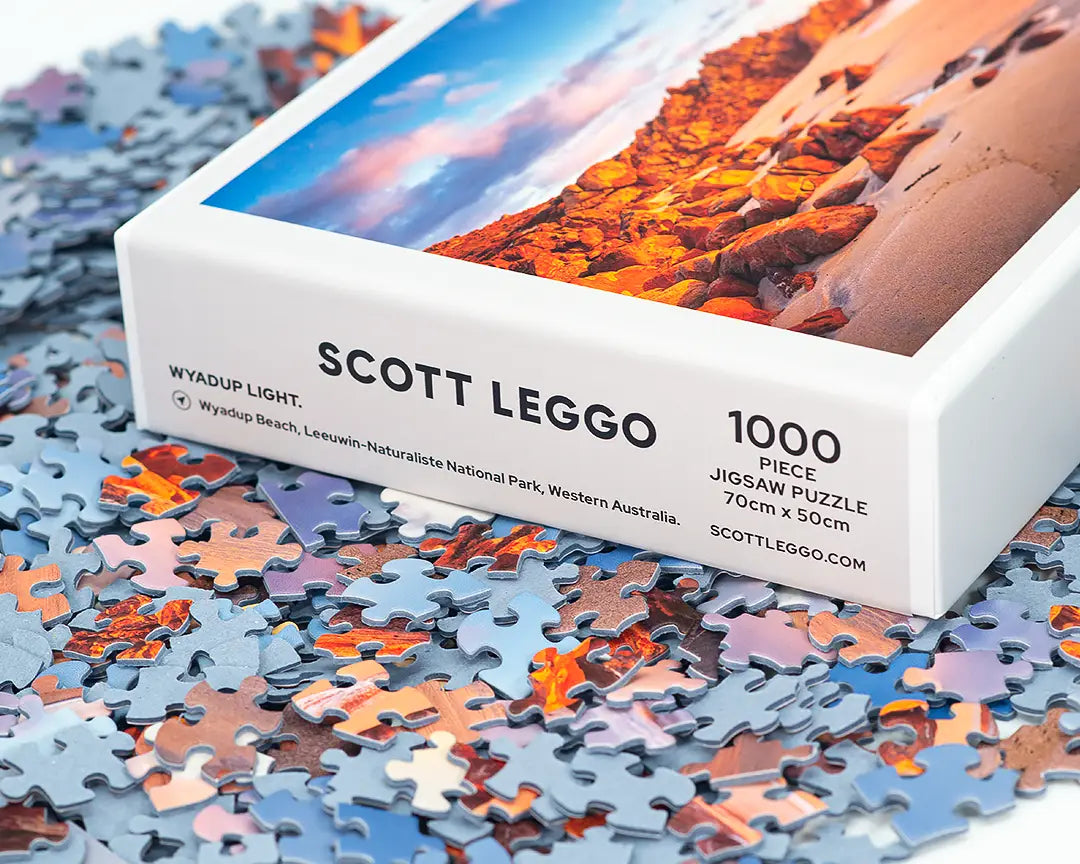 Scott Leggo Jigsaw Puzzle sitting on top of Puzzles Pieces.