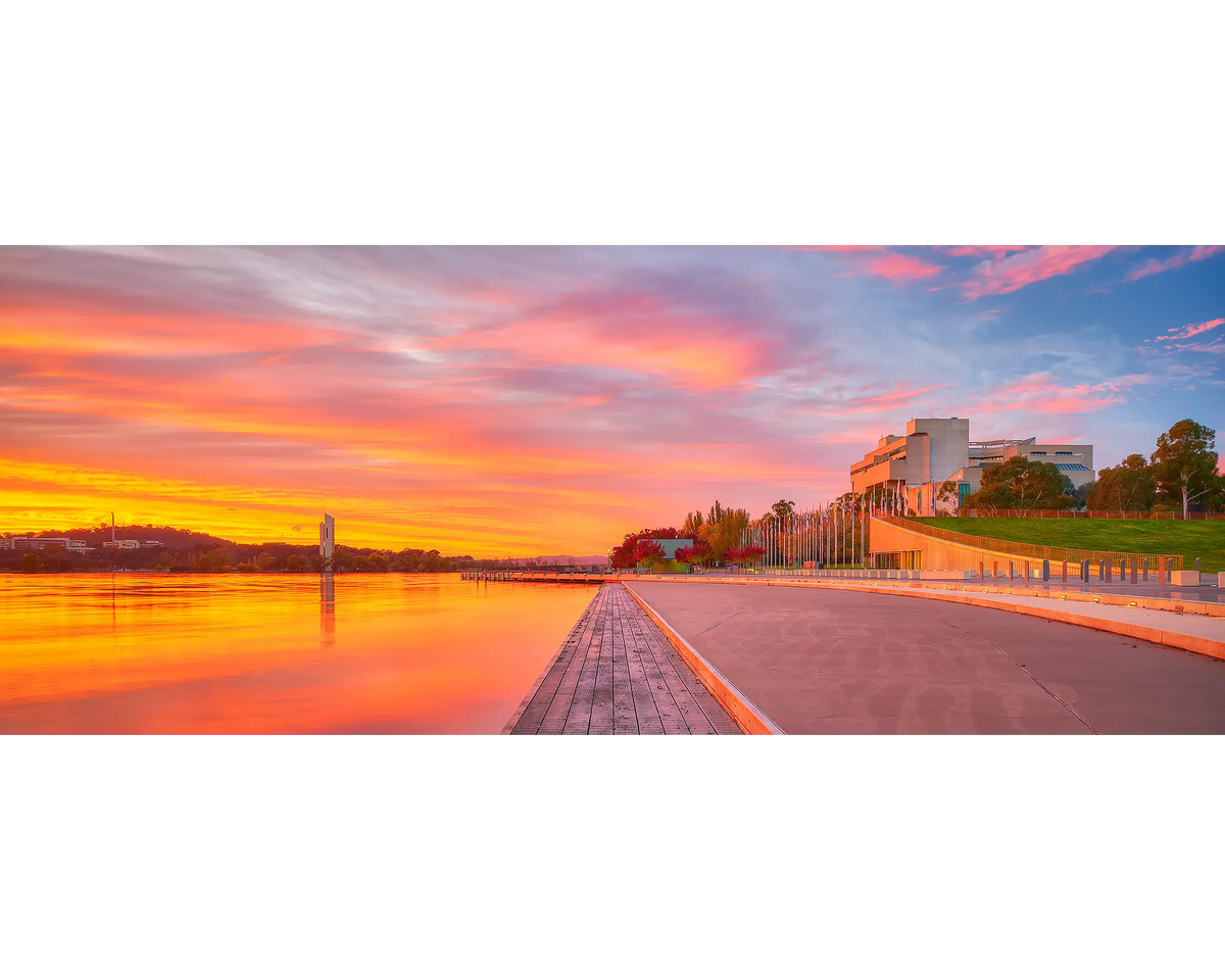 Sky Light. Orange sunrise over Lake BUrley Griffin and The High Court, Canberra, Australia.