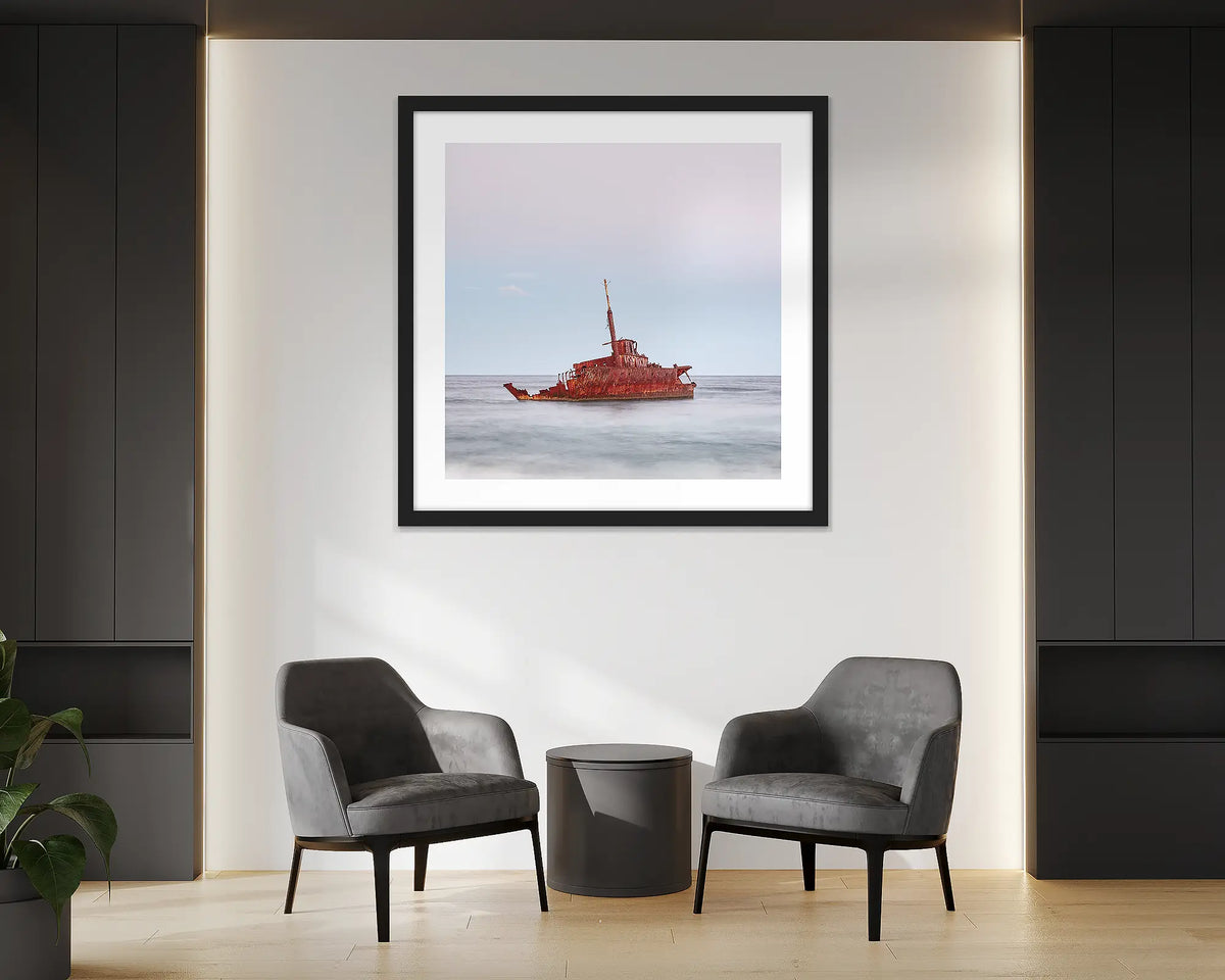 Abandoned. Wall art print of MV Sygna, Stockton Beach, Newcastle, framed in a black frame and hung in an office reception. 