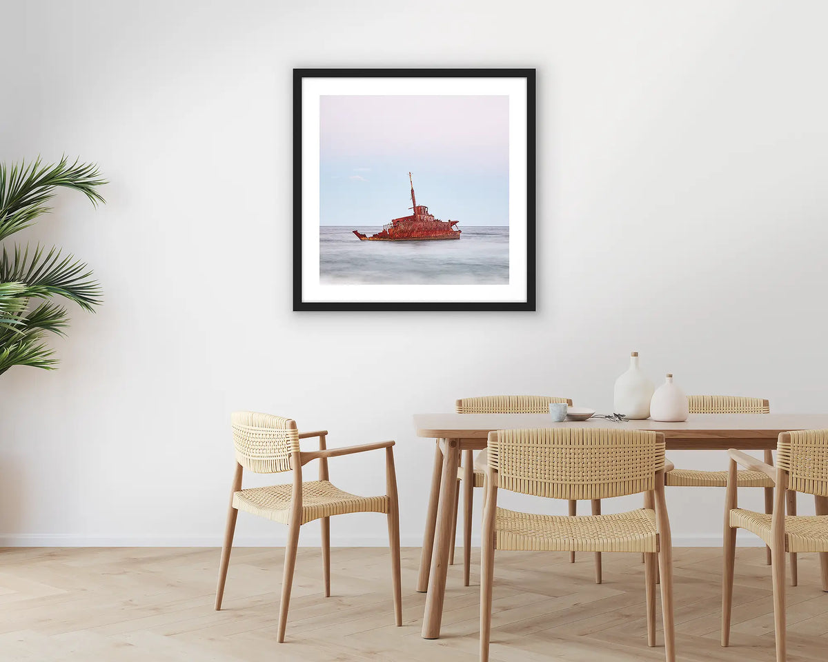 Abandoned. Wall art print of MV Sygna, Stockton Beach, Newcastle, framed in a black frame and hung on a kitchen wall. 