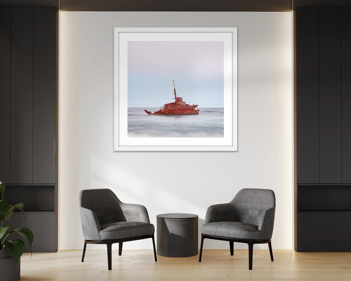 Abandoned. Wall art print of MV Sygna, Stockton Beach, Newcastle, framed in a white frame and hung in an office reception. 
