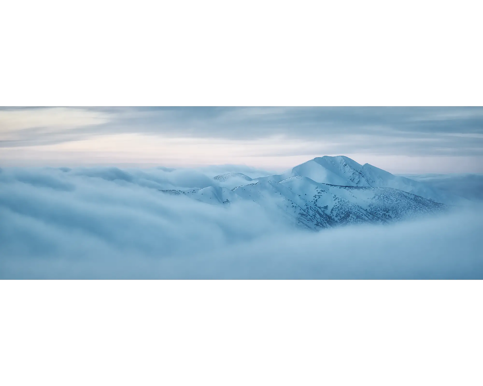 Mount Feathertop with snow surrounded by cloud in the Alpine National Park.