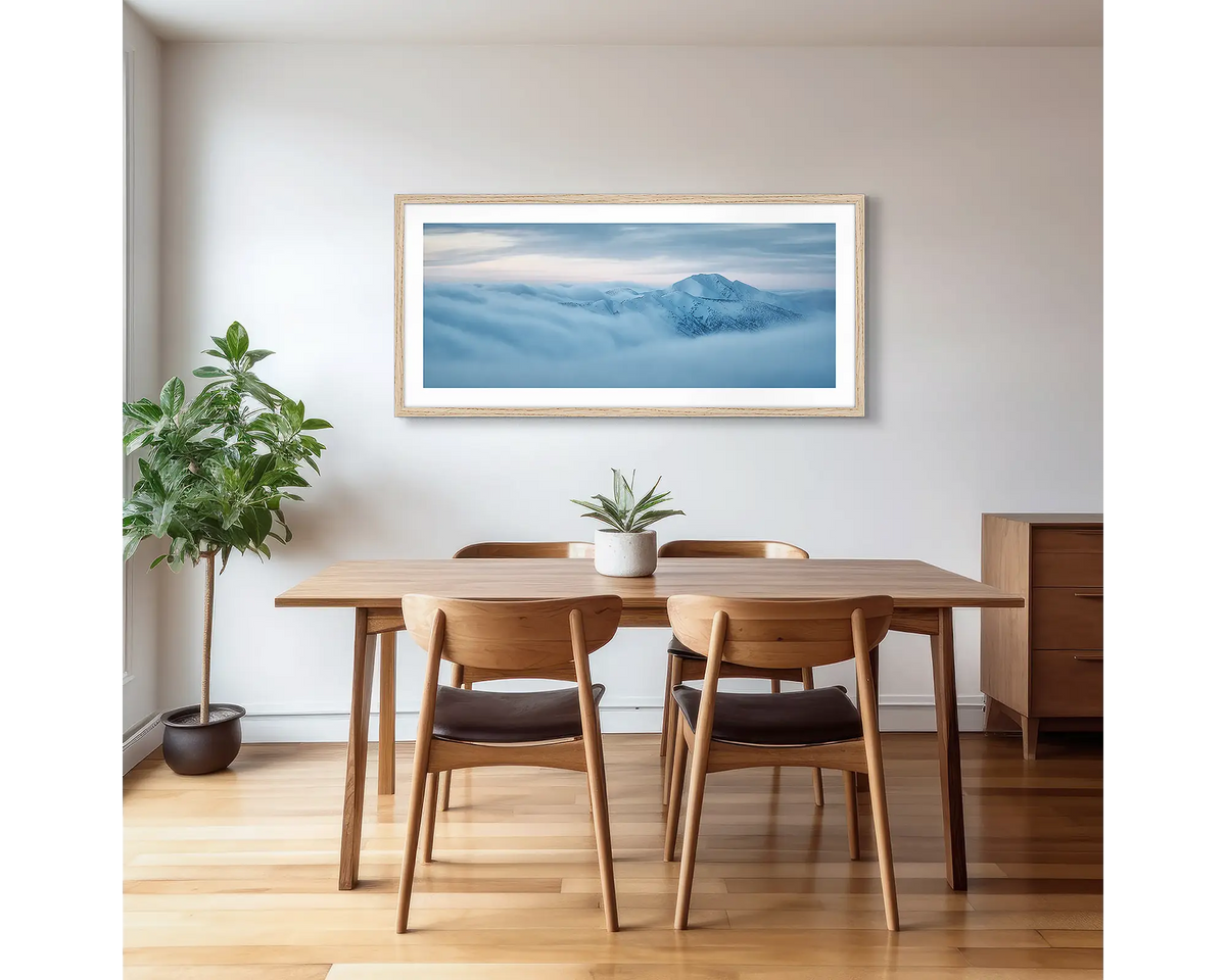 Above it all. Mount Feathertop with snow, surrounded by fog, photographic artwork with a timber frame, hung in a kitchen. 