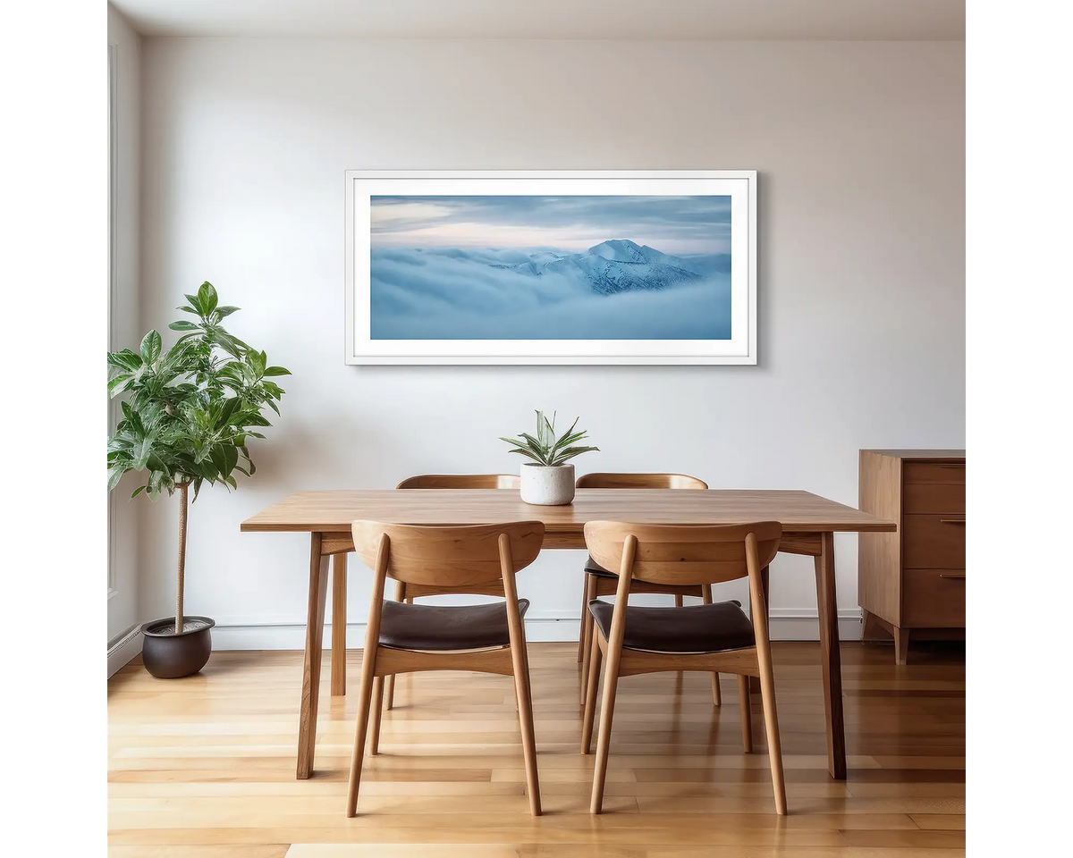 Above it all. Mount Feathertop with snow, surrounded by fog, photographic artwork with a white frame, hung in a kitchen. 