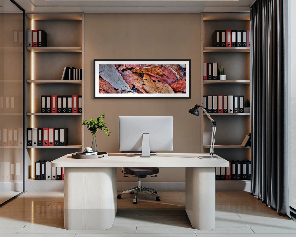After the Fires. Abstract wall art with a black frame hung behind an office desk. 