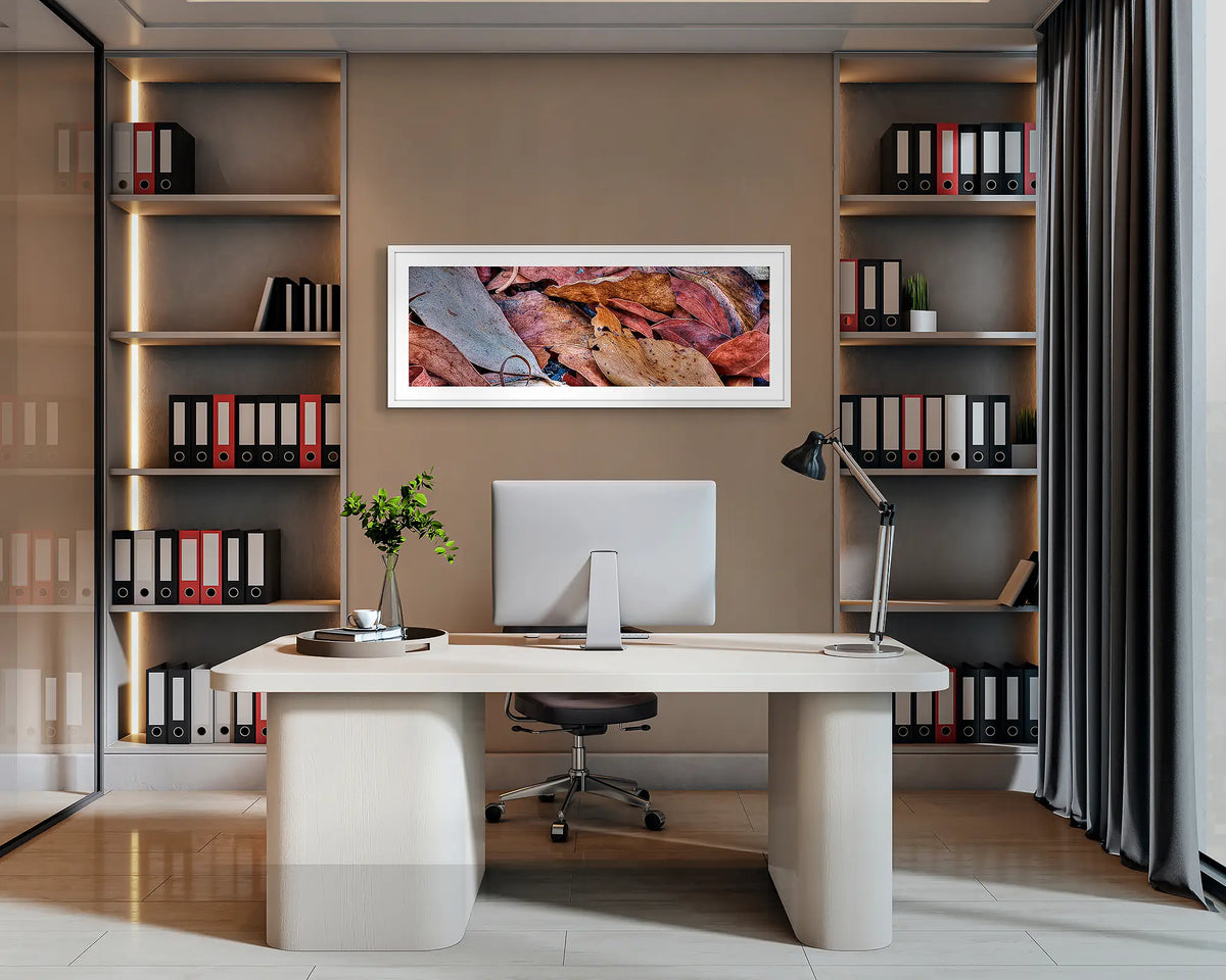 After the Fires. Abstract wall art with a white frame hung behind an office desk. 