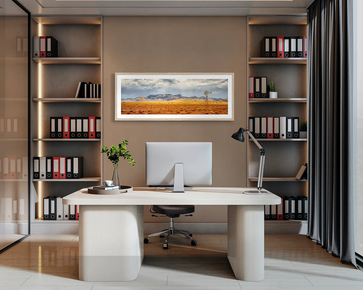 After the Rain. Flinders Ranges, panoramic wall art print with a Tasmanian Oak frame, hung behind an office desk. 