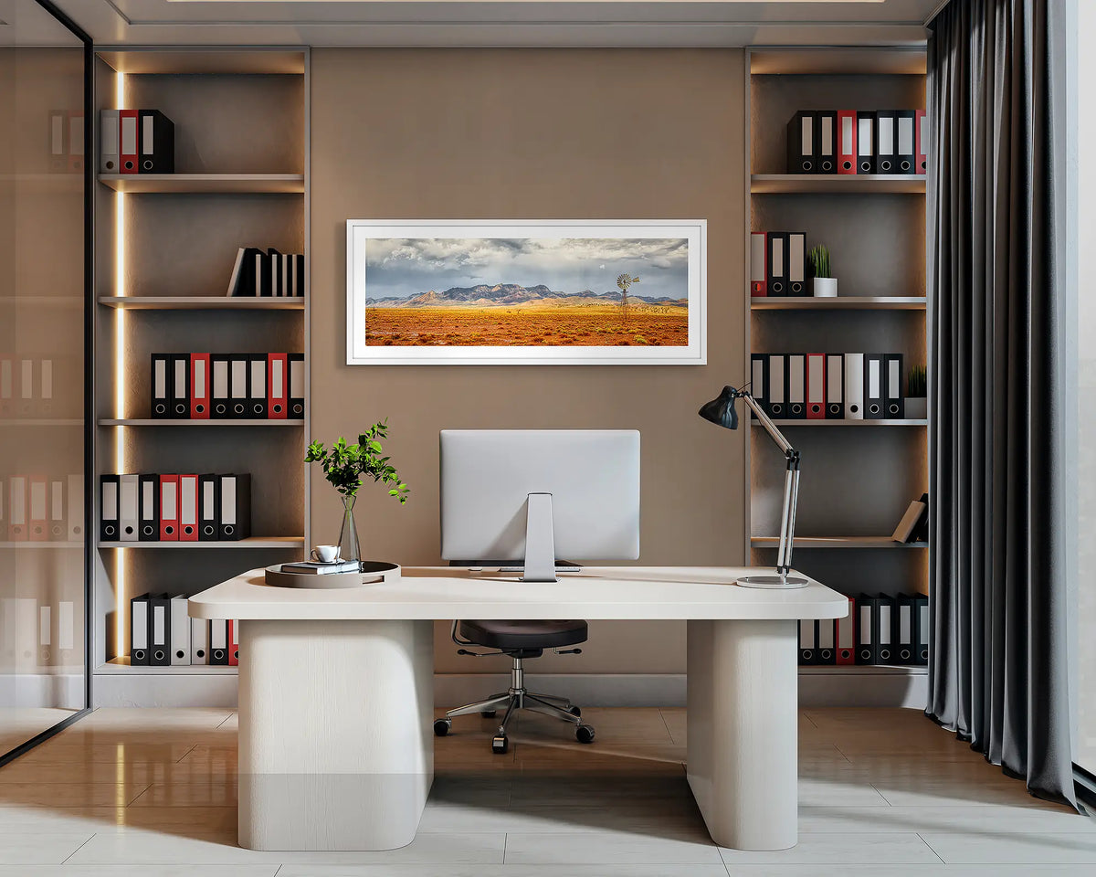 After the Rain. Flinders Ranges, panoramic wall art print with a white frame, hung behind an office desk. 