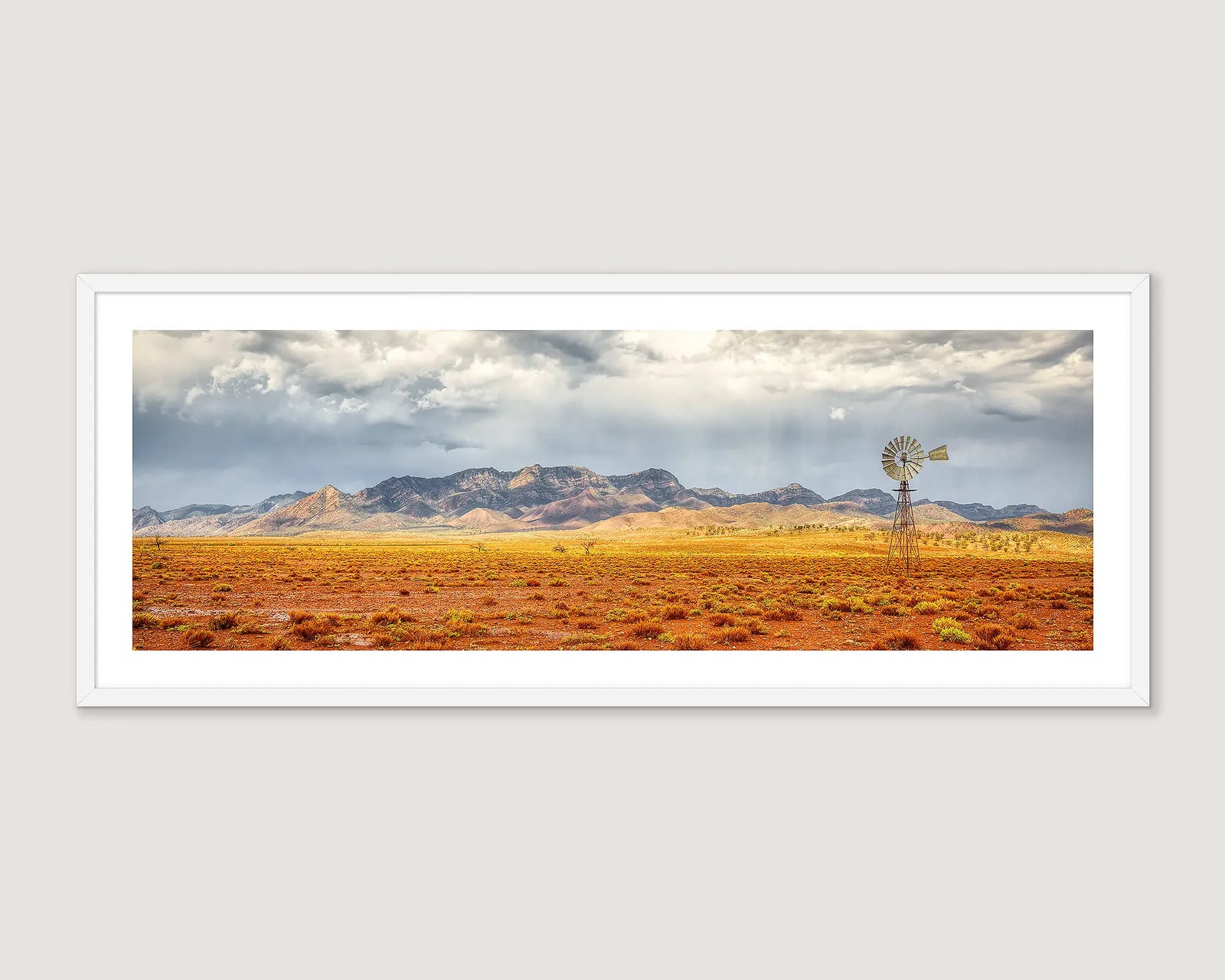 Framed photograph of a windmill and storm clouds over Wilpena Pound. 