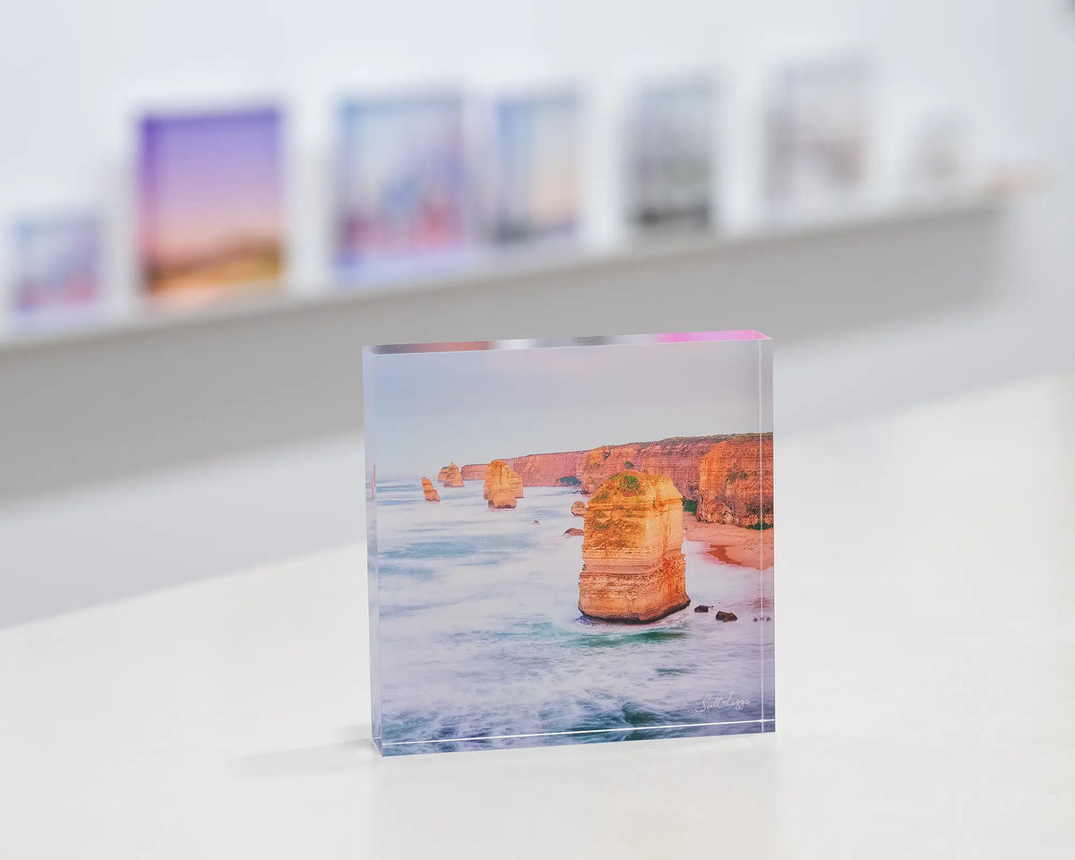 Against The Tide. Acrylic block Twelve Apostles, Great Ocean Road, Victoria, on gallery desk with acrylic blocks in background.