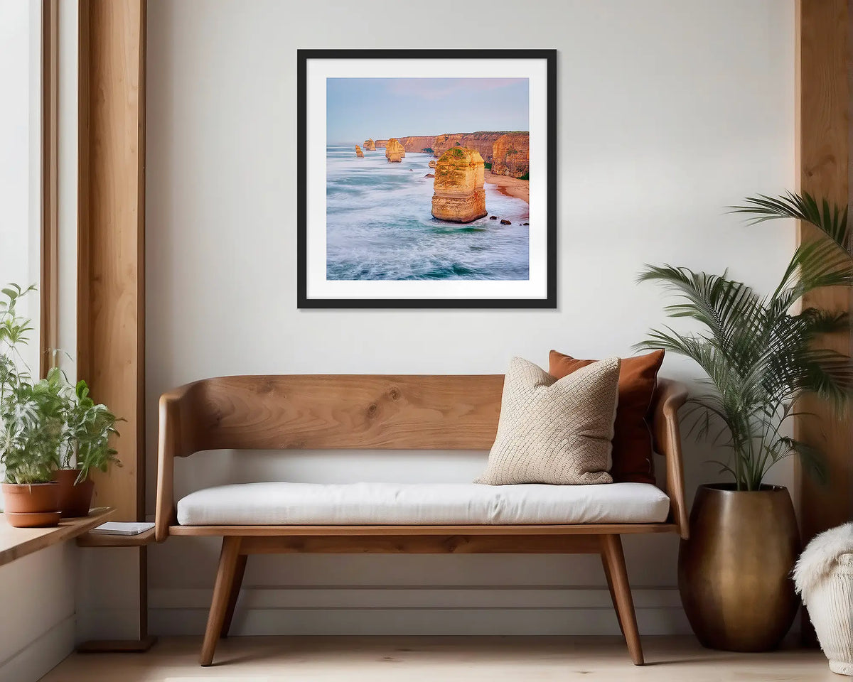 Against the Tide. Black framed wall art print of the Twelve Apostles hung in a scandi-themed waiting area. 