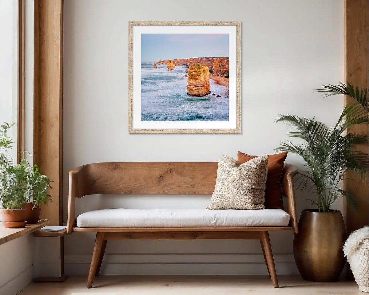 Against the Tide. Timber framed wall art print of the Twelve Apostles hung in a scandi-themed waiting area. 