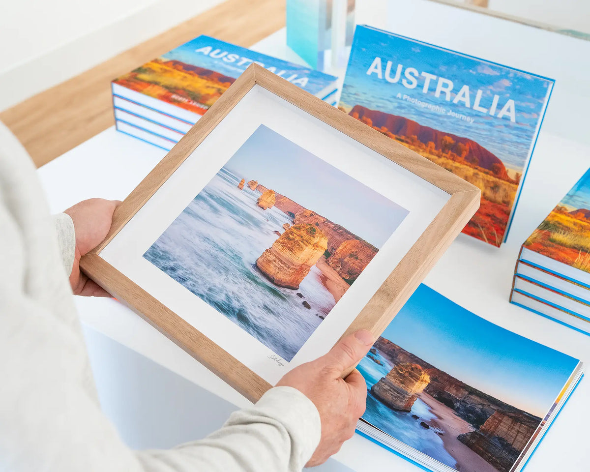 Against The Tide. Twelve Apostles small print with timber frame, hand held in gallery.