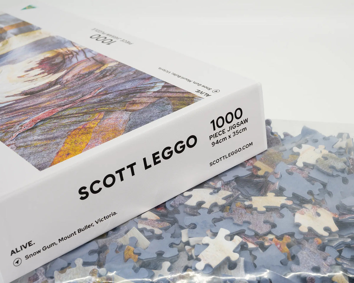 Alive. 1000 piece jigsaw puzzle of Australian snow gum bark patterns, open box showing puzzle pieces.