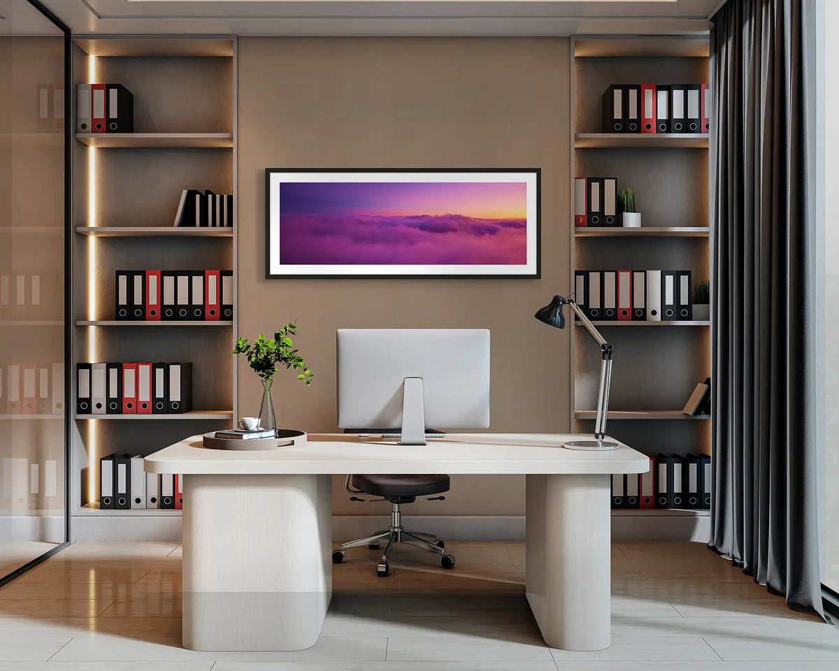Alone. Alpine sunset wall art with a black frame hung behind an office desk. 