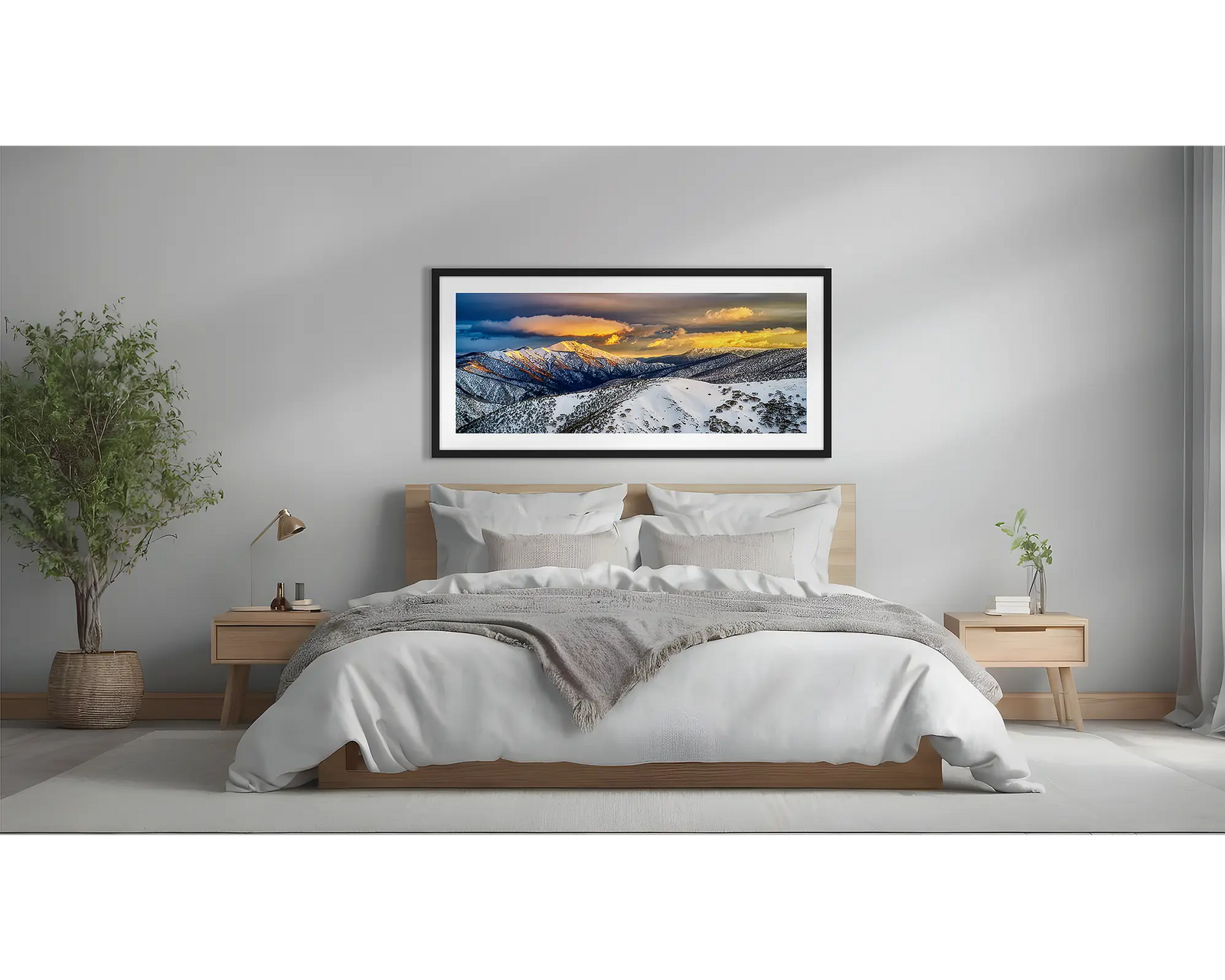 Alpine Magic. Winter snow sunrise wall art  in a black frame above a bed.