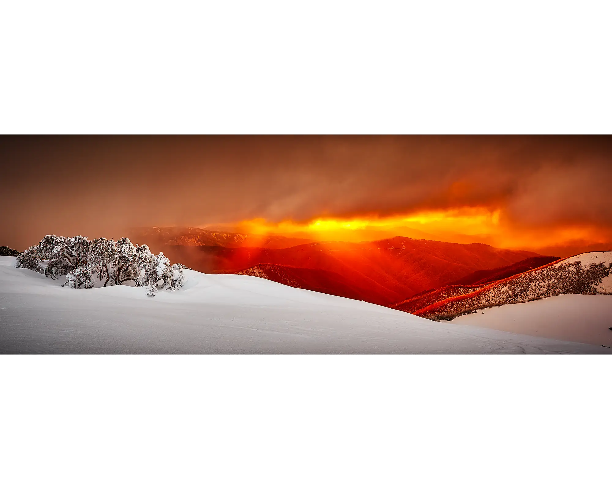 Clouds and rays of light over snow covered Mount Hotham, Victoria. 