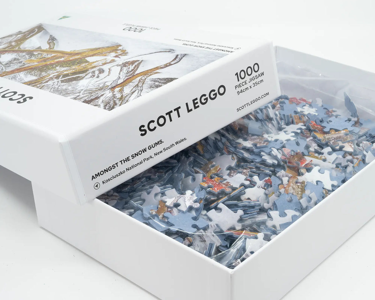 Amongst The Snow Gums. 1000 piece jigsaw puzzle of snow gums, Kosciuszko National Park, open box showing puzzle pieces.