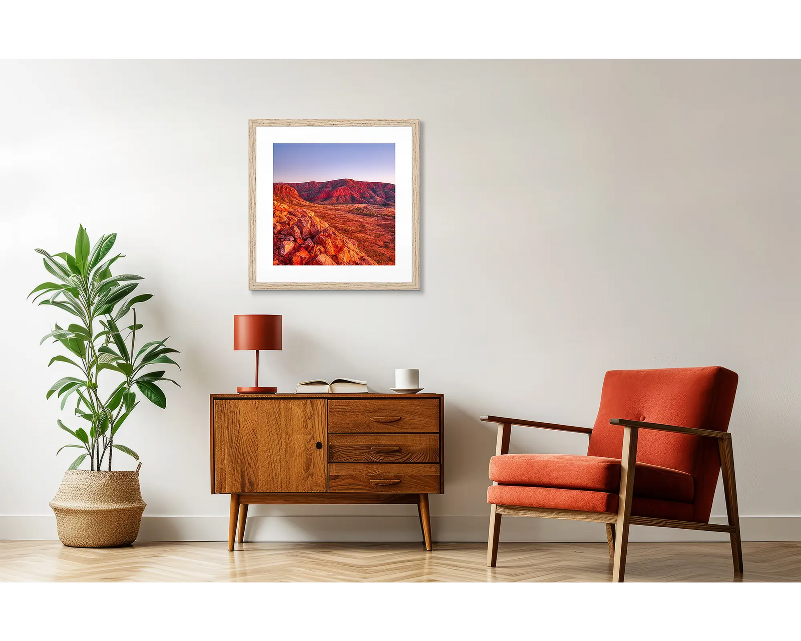 Framed photograph of a desert landscape with red rock formations.