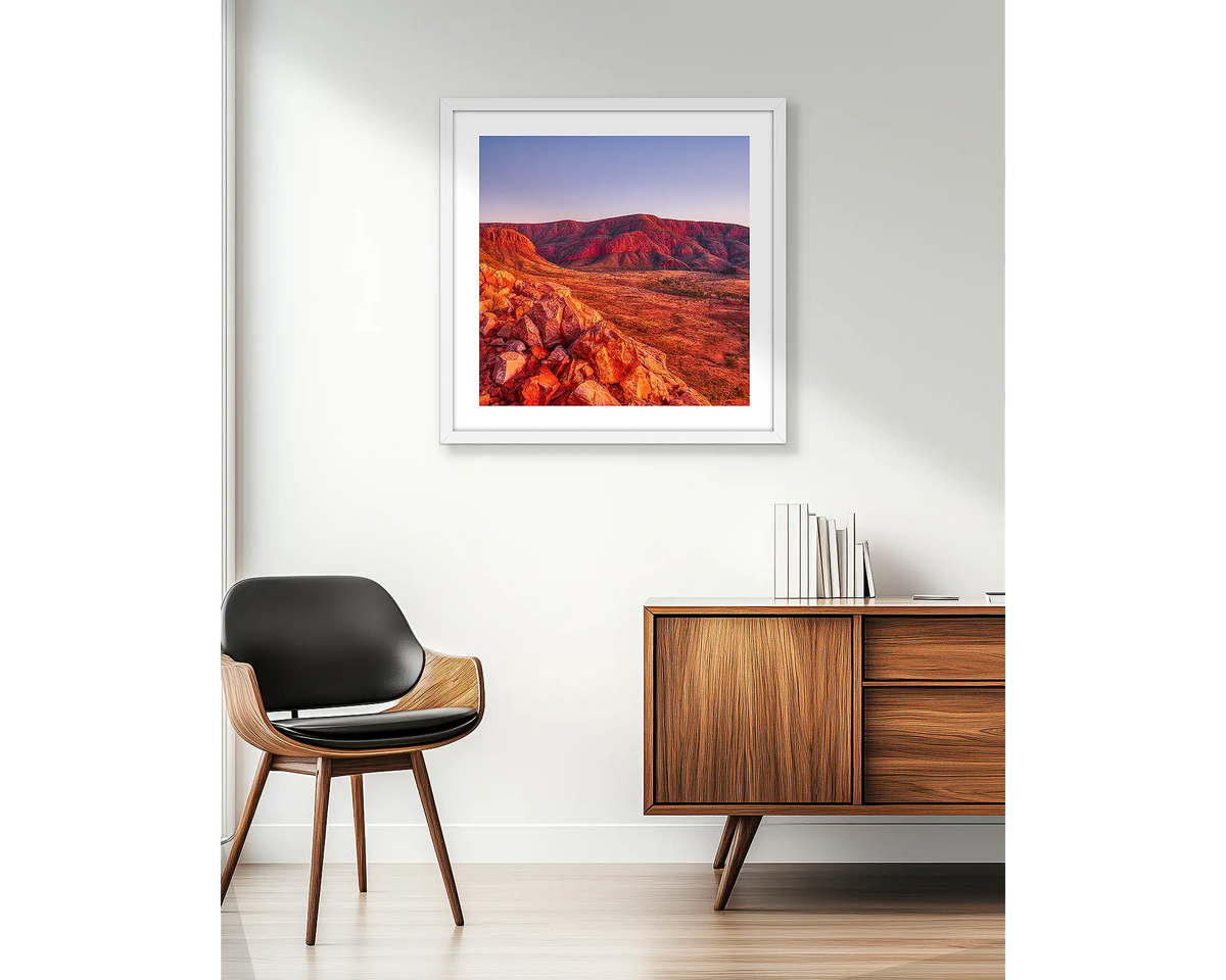 Ancient Dawn. Wall art print of Ormiston Pound at sunrise, in a white frame and hung beside an apartment window.