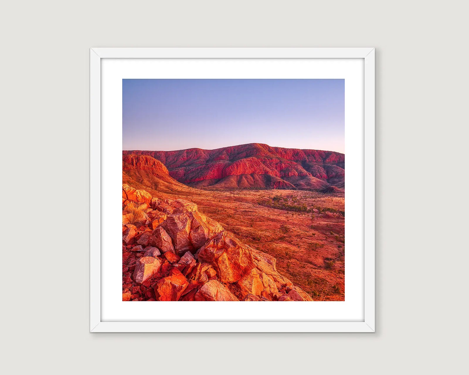Framed photograph of a desert landscape with red rock formations.