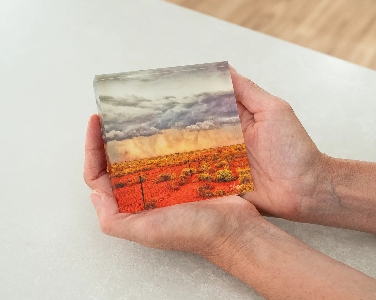 Approaching Storm. Acrylic block of an outback storm South Australia, being held in hands.