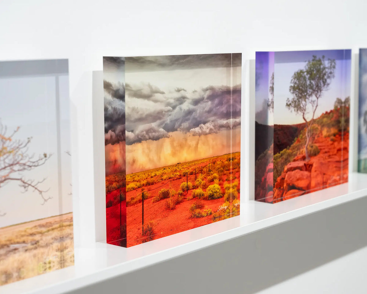 Approaching Storm. Acrylic block of an outback storm, South Australia, on gallery shelf with more outback acrylic blocks.