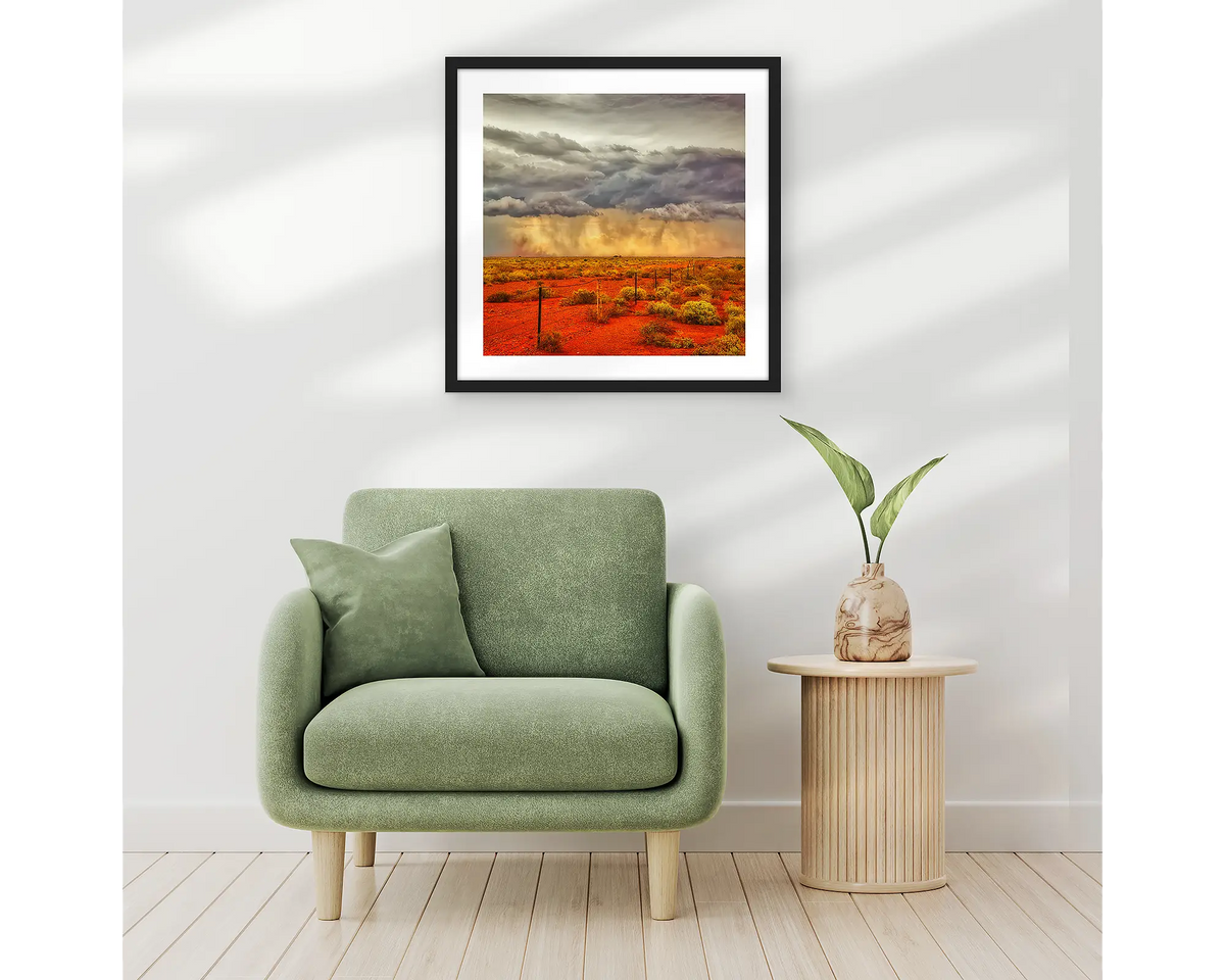 Approaching Storm. Outback artwork in a black frame, and hung in an entrance hallway above a chair. 