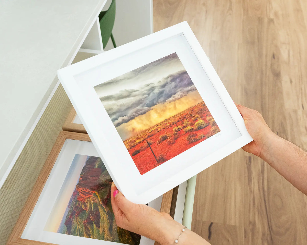 Approaching Storm. Outback artwork of incoming storm clouds South Australia, with white frame being hand held.