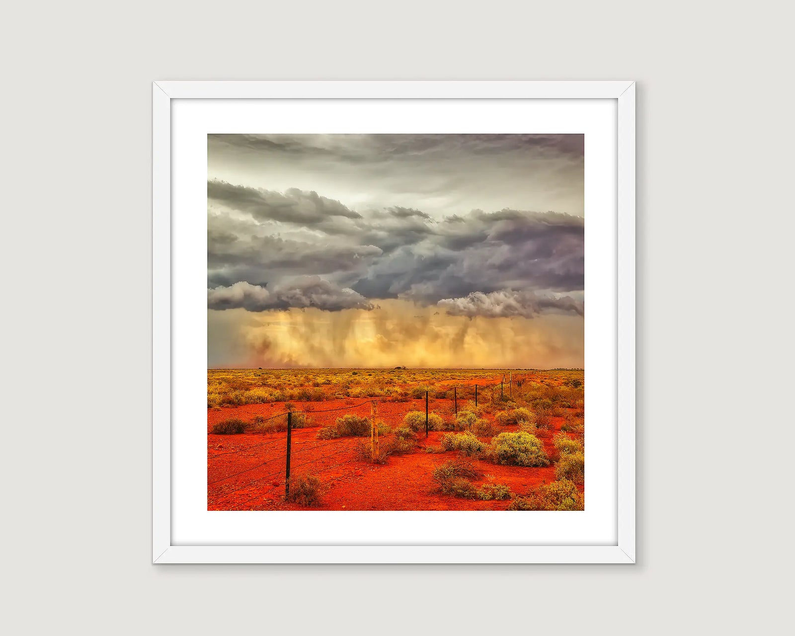 Framed artwork of an outback desert landscape with stormy sky.