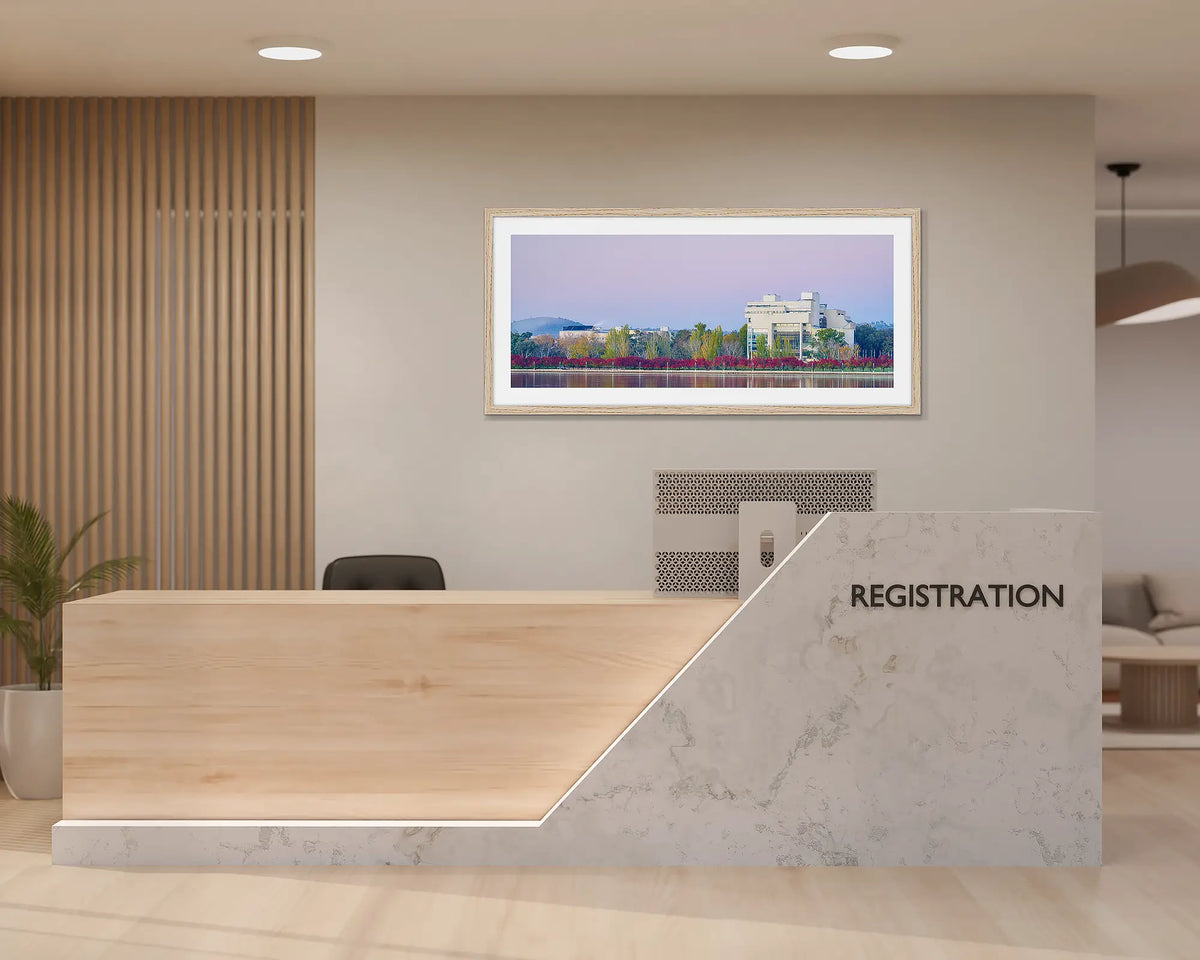 Art and Law. Canberra wall art print with a timber frame hung behind a reception desk. 