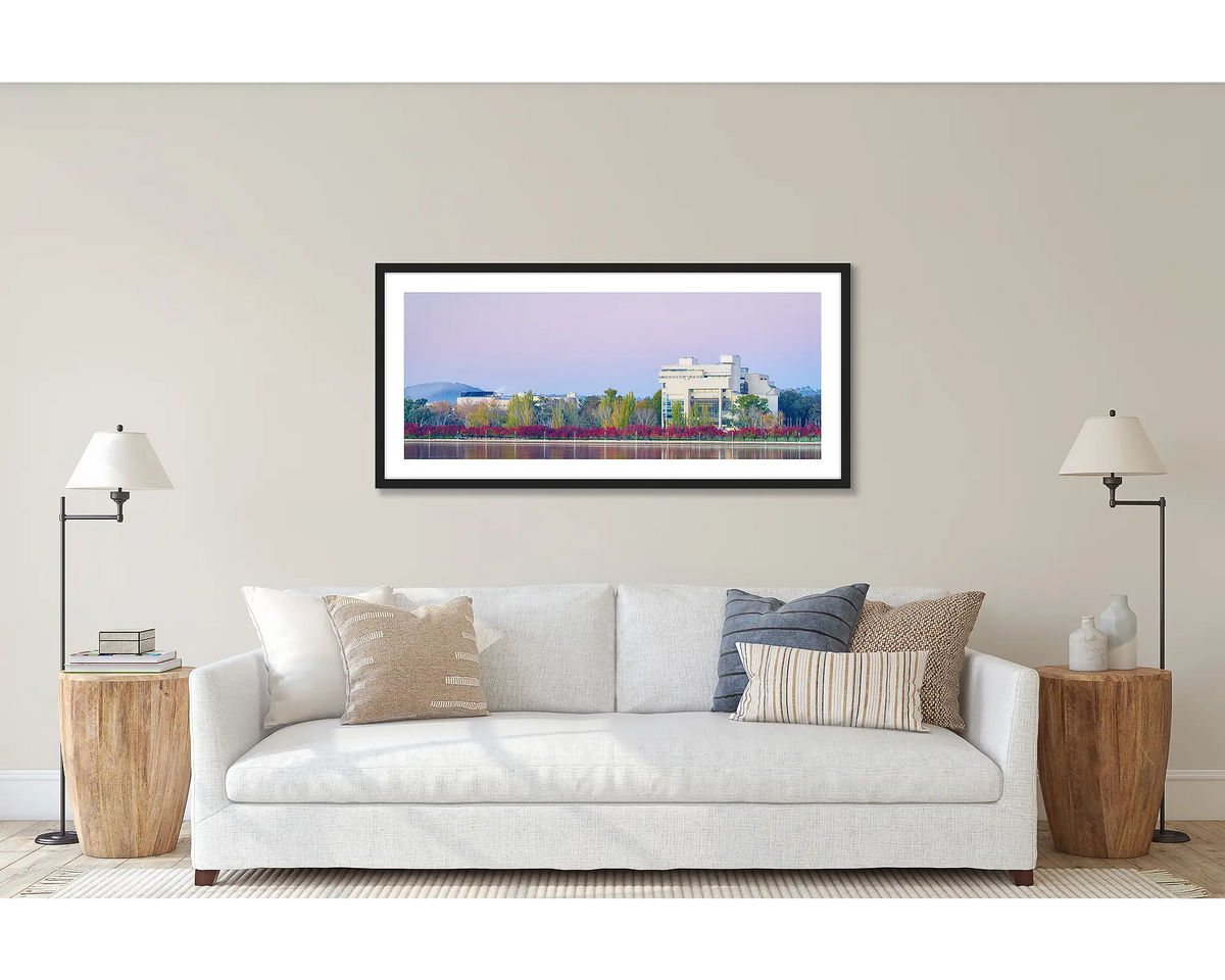 Art and Law. Wall art print of the High Court and National Gallery, framed with a black frame and hung above a couch. 