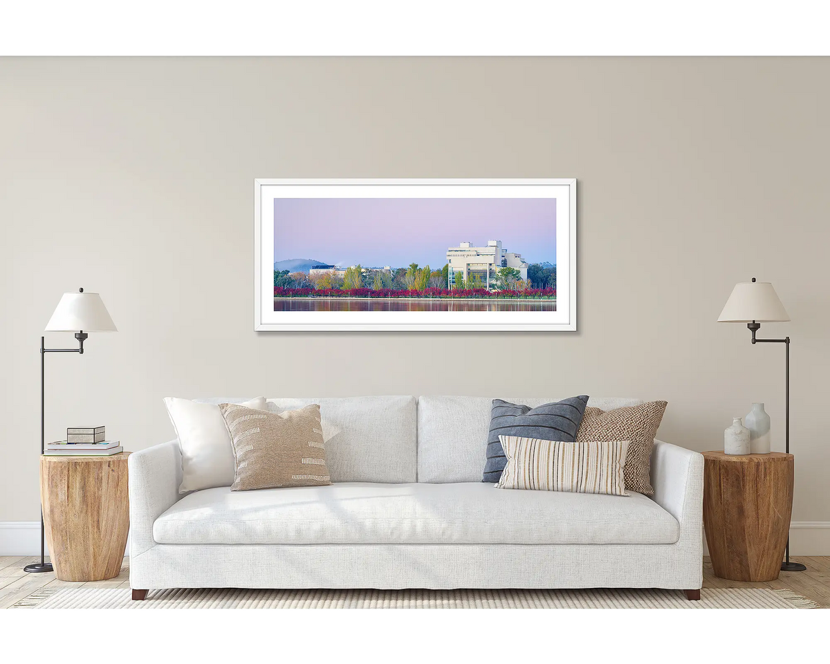 Art and Law. Wall art print of the High Court and National Gallery, framed with a white frame and hung above a couch. 