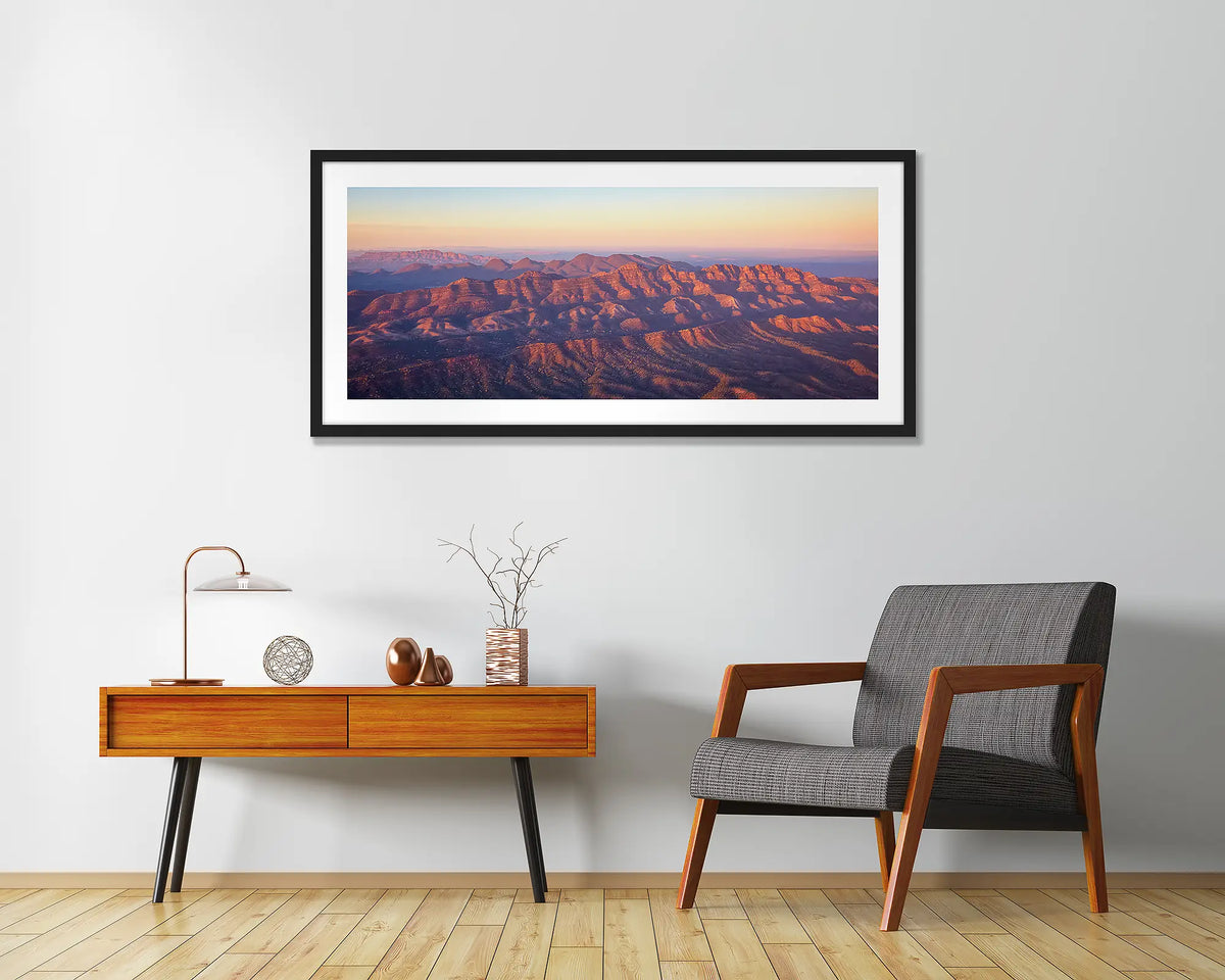 Art of the Ages. Wall art print with a black frame, of a sunrise over Razorback Ridge, Flinders Ranges, hung in a home entrance. 