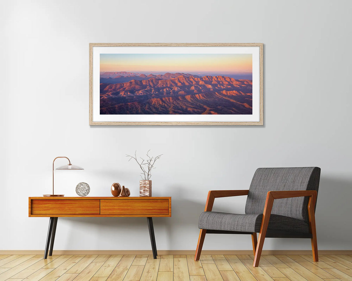 Art of the Ages. Wall art print with a timber frame, of a sunrise over Razorback Ridge, Flinders Ranges, hung in a home entrance. 