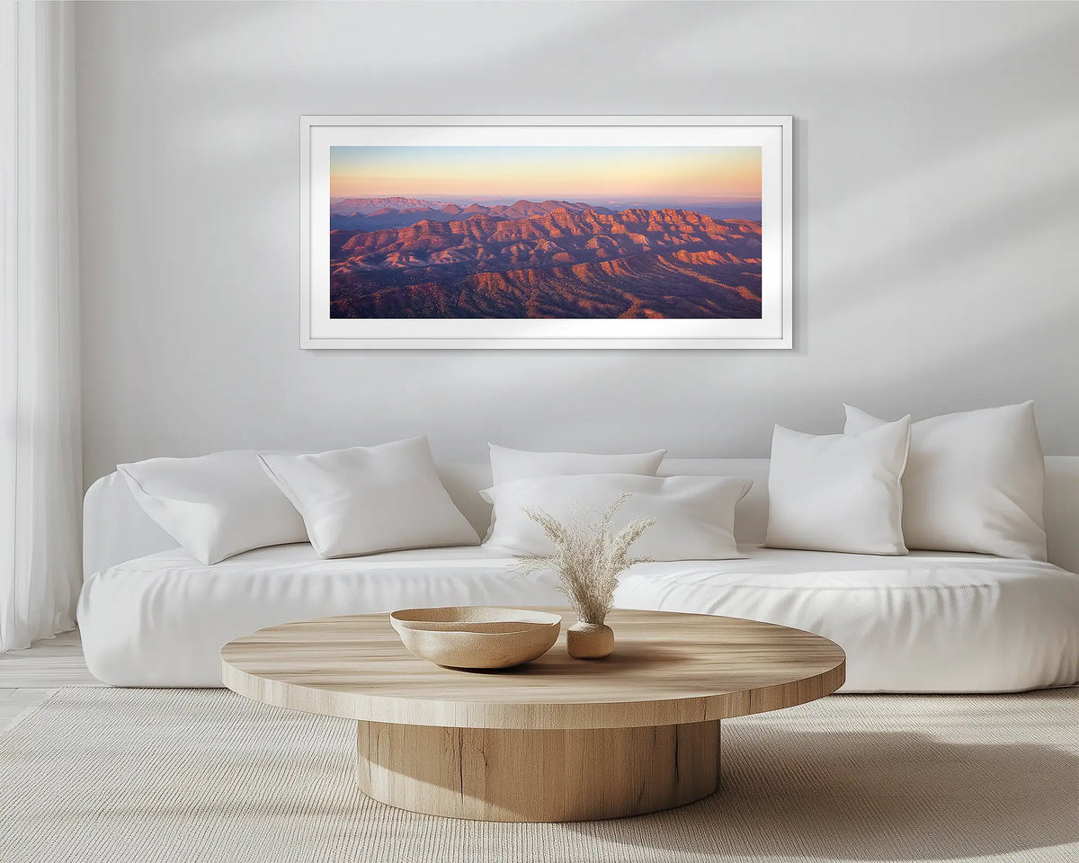 Art of the Ages. White framed wall art print of Flinders Ranges, hung in a scandi-themed lounge room. 