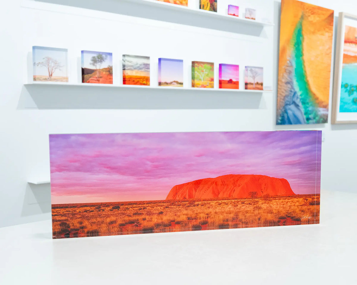 Australian Icon. Acrylic block of Uluru at sunset, Northern Territory, on desk in gallery.