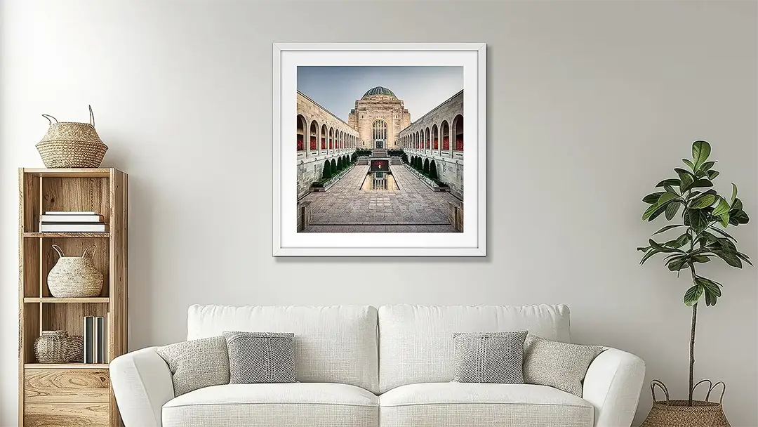 Australian War Memorial wall art in white frame above couch.