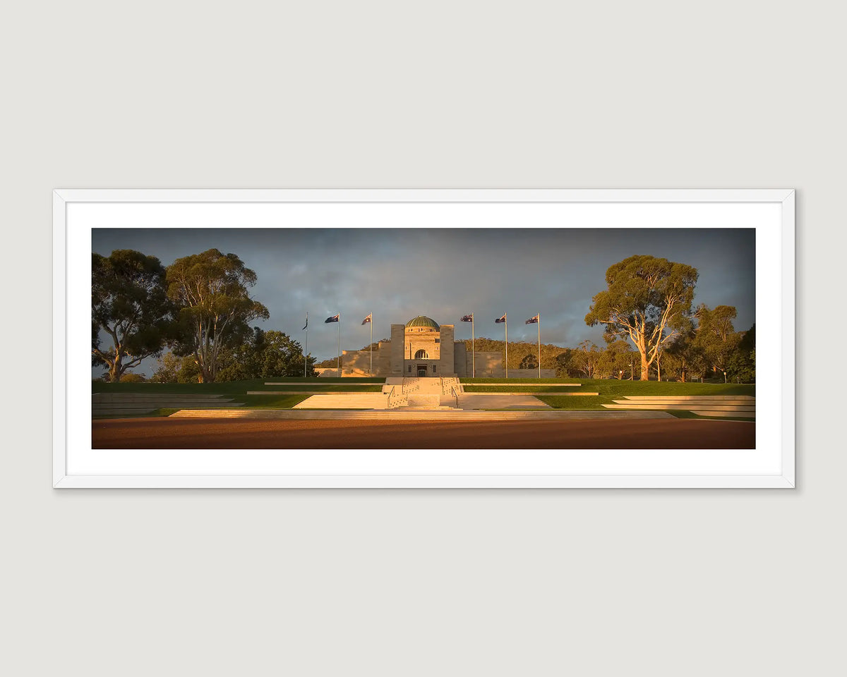 Framed photographic print of the Australian War Memorial at the foot of Mount Ainslie, and surrounded by gum trees. 