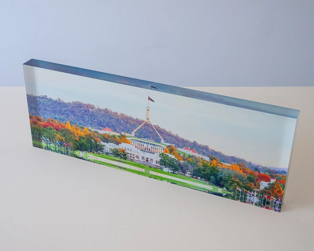Autumn Bubble. Acrylic block of colourful autumn trees in front of Old and New Parliament House, top view.