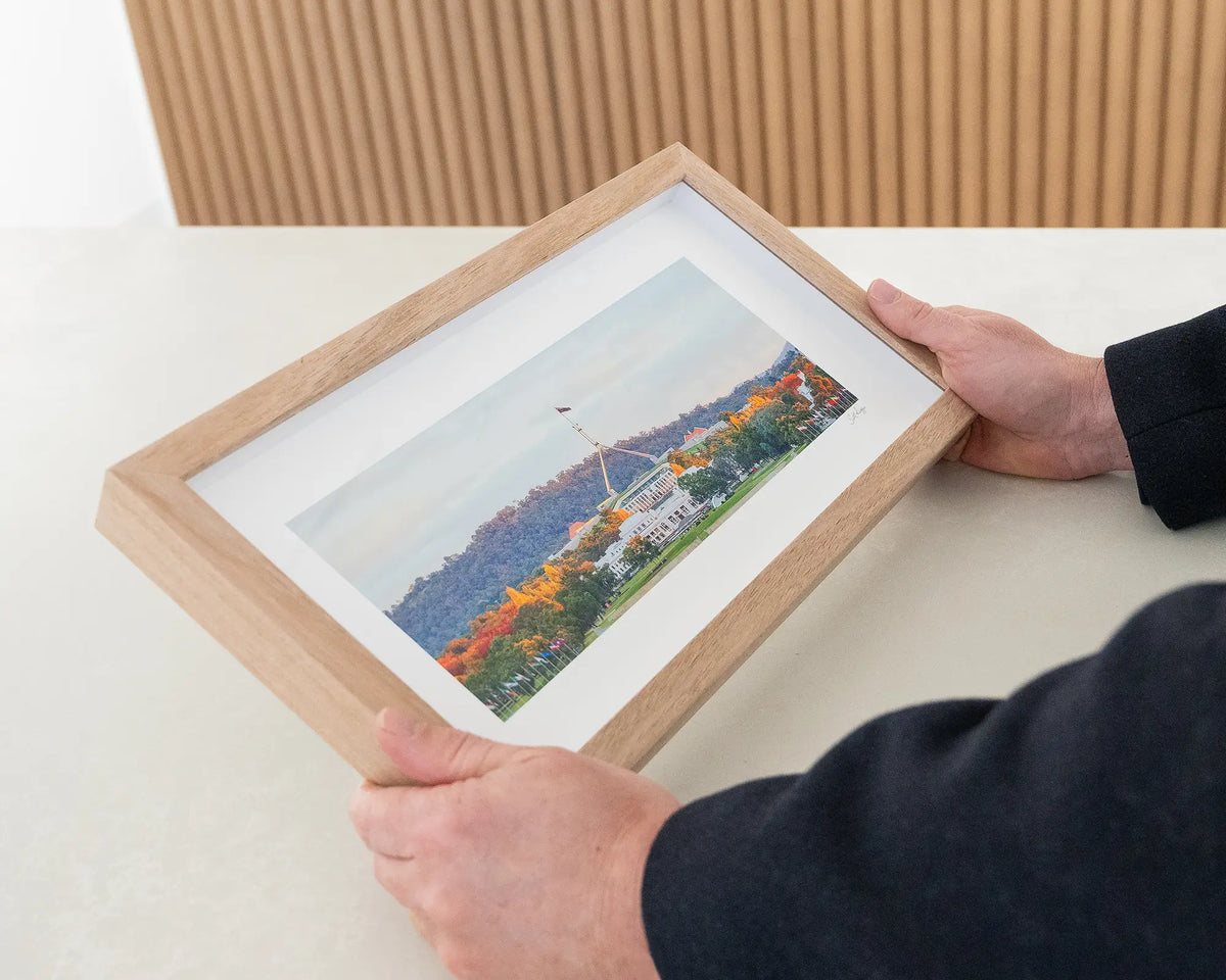 Autumn Bubble. Canberra sunset over Parliament House, small framed print being hand held.
