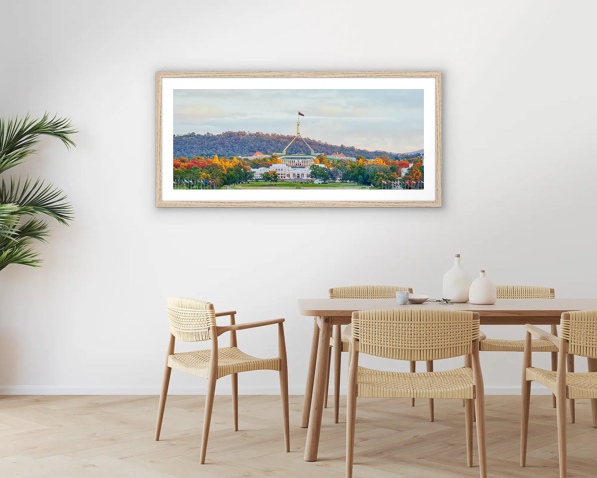 Autumn Bubble. Photographic wall art print with a timber frame, of old and new parliament house, Canberra, hung in a dining room. 