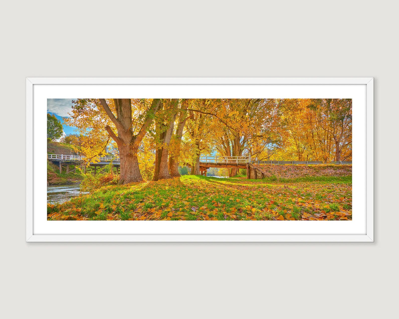 Framed photographic print of autumn leaves turning gold beside the Murray River. 