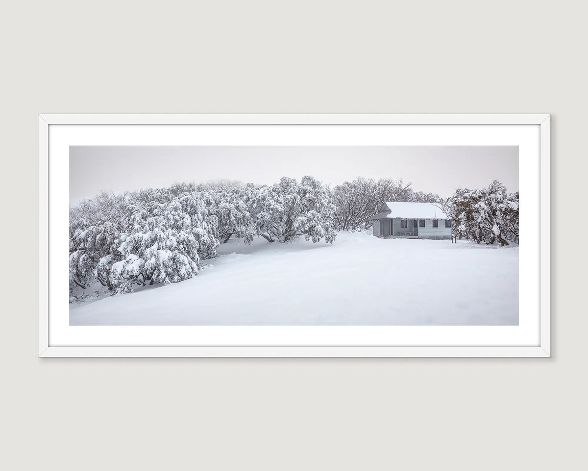 Framed wall art print of Federation Hut covered in fresh snow and surrounded by snow gums covered in ice. 