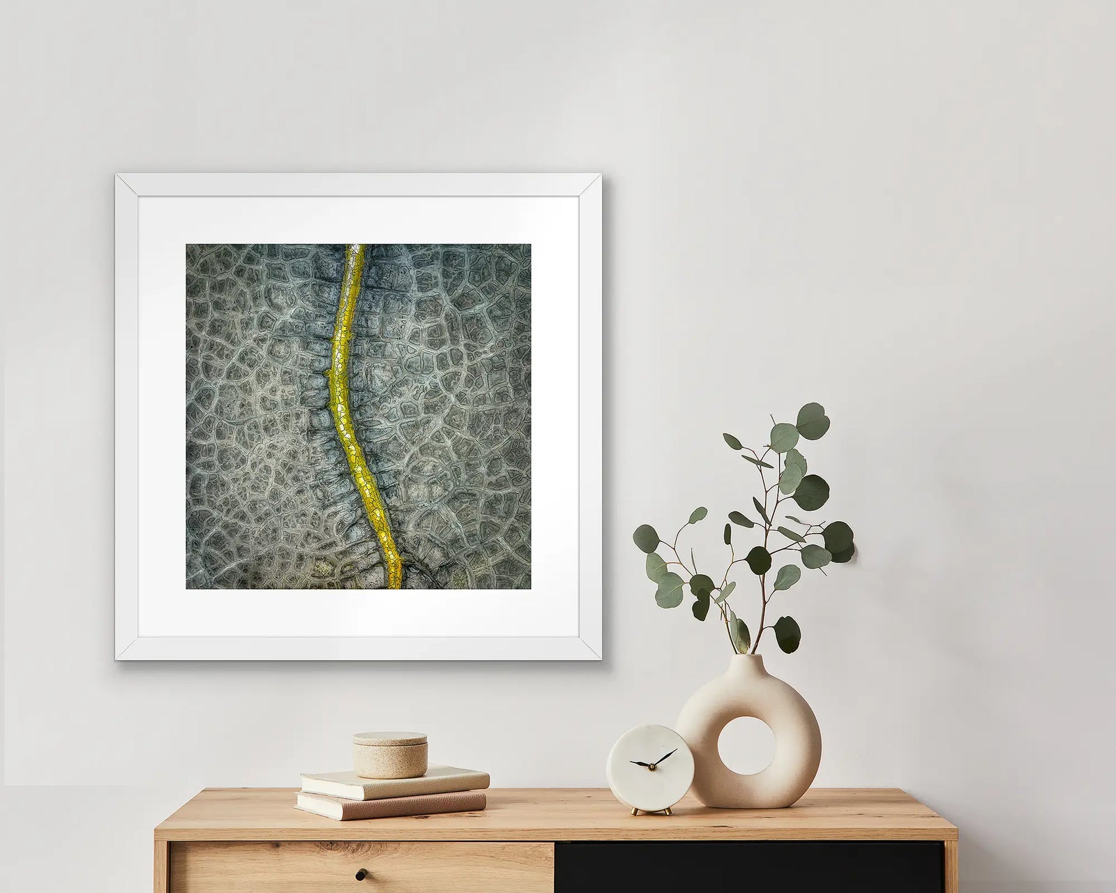 Framed abstract photographic print of a dried up dam. 