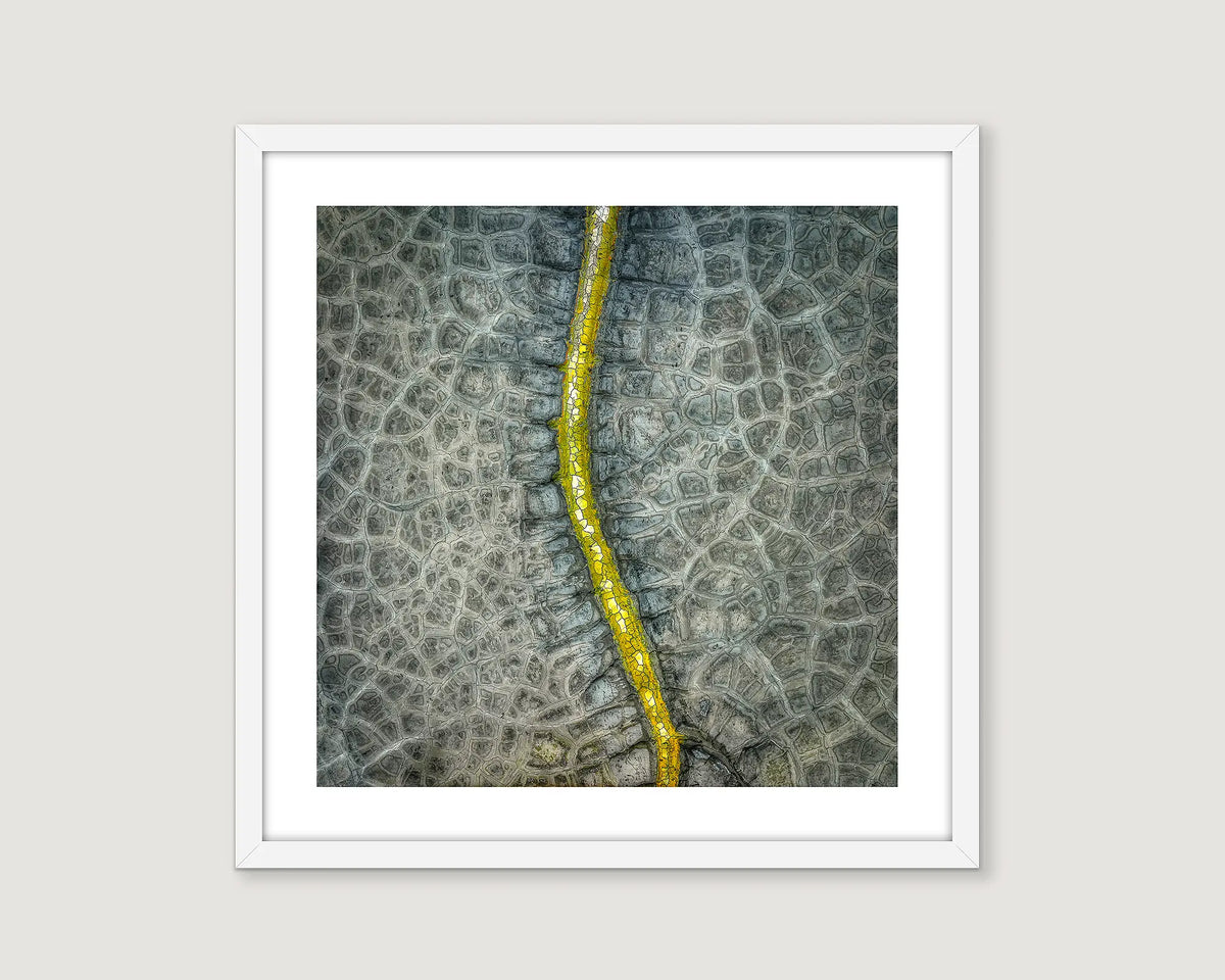 Framed abstract photographic print of a dried up dam. 