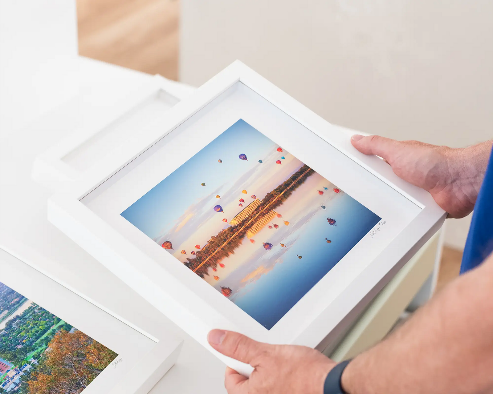 Framed photograph of balloons floating above Lake Burley Griffin during the Canberra Balloon Spectacular festival.